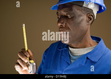 African American Construction Worker Holding a Tape Measure Stock Photo