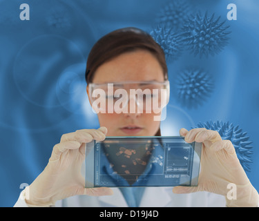 Nurse wearing glasses and holding a virtual screen Stock Photo