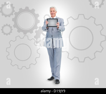 Smiling businessman holding a tablet Stock Photo