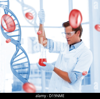 Serious scientist putting chemicals in a test-tube Stock Photo