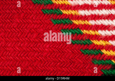 Handmade knit green and red background. Close up structure of the yarn. Christmas colors Stock Photo