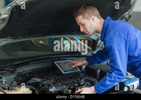 Mechanic using tablet pc Stock Photo