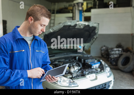 Auto mechanic working on tablet pc Stock Photo