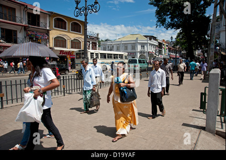 A woman in yellow sari out in the crowds of Kandy Sri Lanka Stock Photo