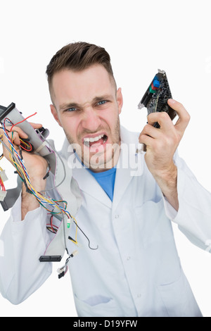 Portrait of young it professional yelling with cpu parts in hands Stock Photo