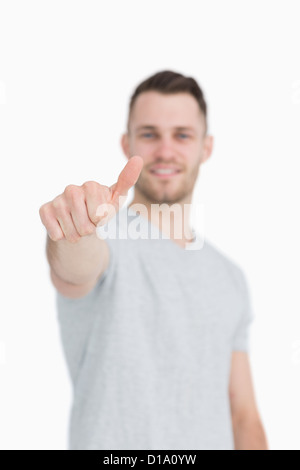 Casual young man gesturing thumbs up Stock Photo