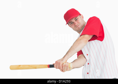 Portrait of young baseball player swinging bat Stock Photo