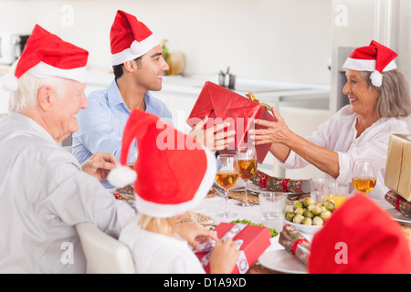 Happy family exchanging christmas gifts Stock Photo