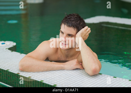 Smiling man relaxing in the pool Stock Photo