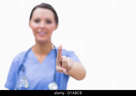 Female surgeon pointing on invisible screen Stock Photo
