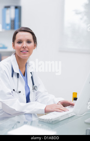 Confident female doctor using computer at clinic Stock Photo