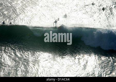 Surfers watching another surfer wipe out on a big wave, Maui, Hawaii Stock Photo