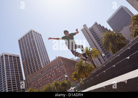 Young man jumping on skateboard - San Francisco, California USA Stock Photo