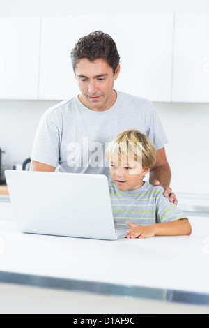 Father and son using laptop Stock Photo