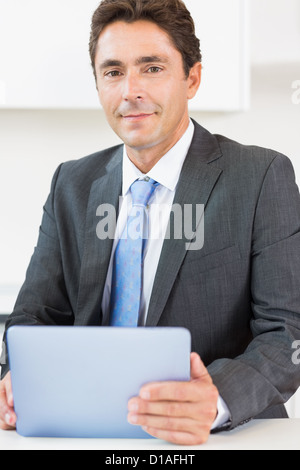 Man in suit using tablet Stock Photo