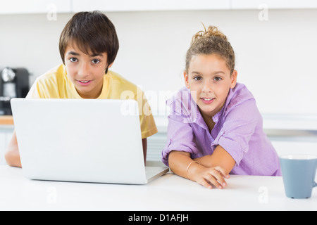 Siblings using laptop Stock Photo