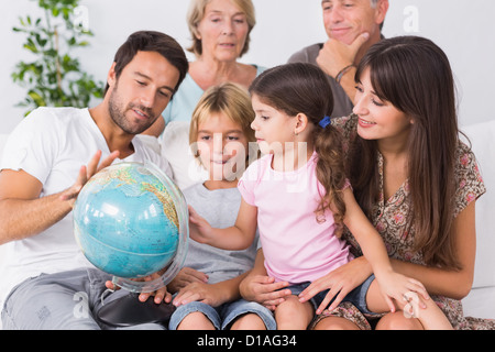 Happy family looking at globe Stock Photo