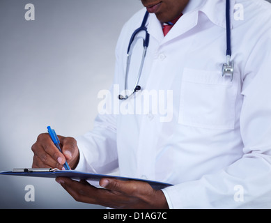 Close-up of confident doctor writing prescription Stock Photo