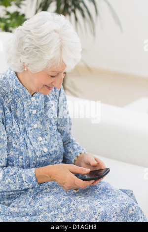 Elderly happy woman using a smartphone Stock Photo