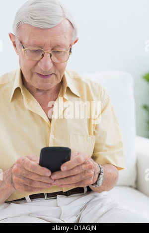 Calm elderly man using his smartphone Stock Photo