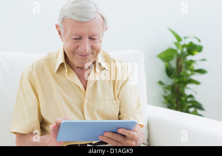Elderly man using a digital tablet Stock Photo