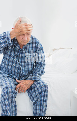 Old man suffering on the bed Stock Photo