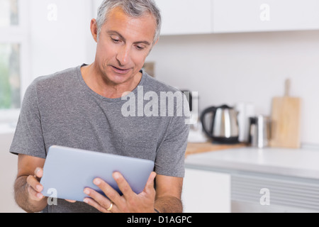 Mature man using his digital tablet Stock Photo