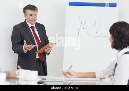 Businessman explaining to his colleague Stock Photo