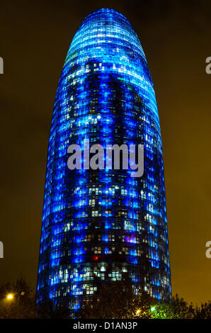 Barcelona, Spain. 12th December 2012 -- The Torre Agbar pictured lit up for the Christmas season with more than 4,500 lights that can operate independently using LED technology displaying a seasonal design out of moving lights and colors in Barcelona. -- The Torre Agbar, a 38-story skyscraper and an example of high-tech architecture on Barcelona's skyline, adds to the city's traditional Christmas lighting, displaying an original decoration of moving lights and colors using LED technology. Stock Photo