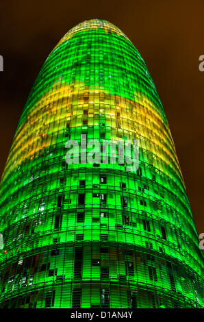 Barcelona, Spain. 12th December 2012 -- The Torre Agbar pictured lit up for the Christmas season with more than 4,500 lights that can operate independently using LED technology displaying a seasonal design out of moving lights and colors in Barcelona. -- The Torre Agbar, a 38-story skyscraper and an example of high-tech architecture on Barcelona's skyline, adds to the city's traditional Christmas lighting, displaying an original decoration of moving lights and colors using LED technology. Stock Photo