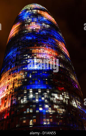 Barcelona, Spain. 12th December 2012 -- The Torre Agbar pictured lit up for the Christmas season with more than 4,500 lights that can operate independently using LED technology displaying a seasonal design out of moving lights and colors in Barcelona. -- The Torre Agbar, a 38-story skyscraper and an example of high-tech architecture on Barcelona's skyline, adds to the city's traditional Christmas lighting, displaying an original decoration of moving lights and colors using LED technology. Stock Photo