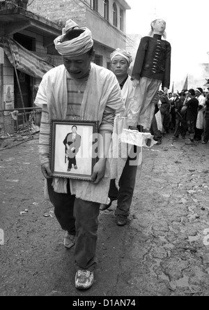 Man Holding The Picture Of The Dead During Funeral Procession, Yuanyang, Yunnan Province, China Stock Photo