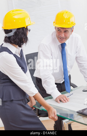 Two architects speaking with yellow helmet and smile Stock Photo