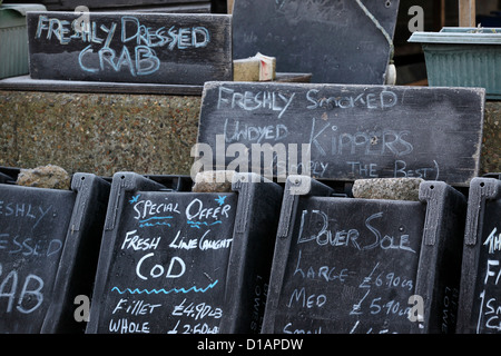 Fresh fish, dressed crab, for sale notice boards outside of fish shack, Aldeburgh, Suffolk, UK Stock Photo