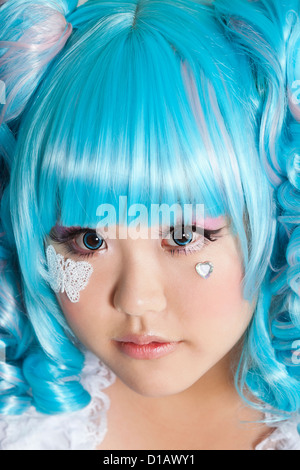 Portrait cute woman wearing blue wig over