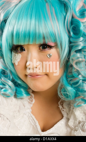Portrait young woman blue hair dressed as a doll