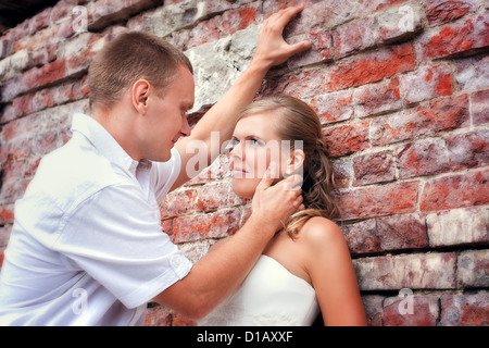 Young Bride and groom posing near castle Stock Photo