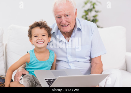 Grandfather and grandson with a laptop Stock Photo
