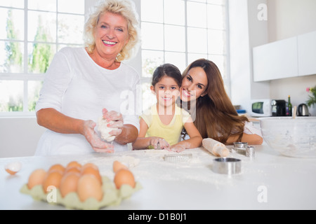 Smiling women of a family baking together Stock Photo