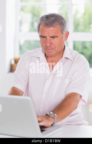 Old man using laptop seriously Stock Photo