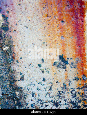 Old cement wall with strong red-brown rust stains and concrete. Stock Photo