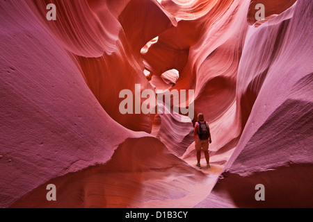 Female Tourist Hiker and Sandstone Rock Formations, Lower Antelope Canyon, Page, Arizona, USA United states of America Stock Photo