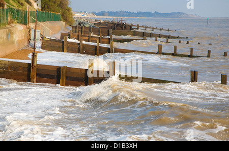 Waves wooden groynes sea defences Cobbold's Point, Felixstowe, Suffolk, England Stock Photo