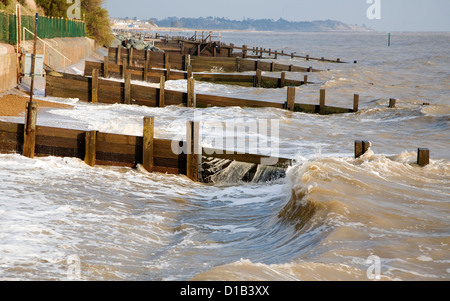 Waves wooden groynes sea defences Cobbold's Point, Felixstowe, Suffolk, England Stock Photo