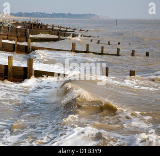 Waves wooden groynes sea defences Cobbold's Point, Felixstowe, Suffolk, England Stock Photo
