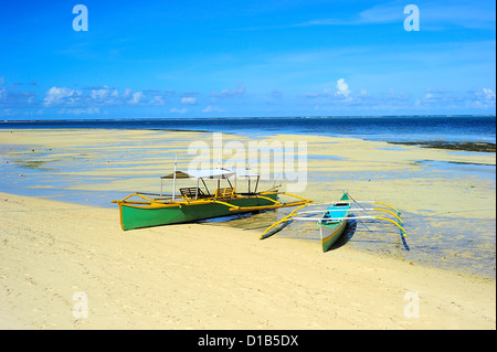 Traditional Philippines boats on the beach during the low tide on Shiargao island, Philippines Stock Photo