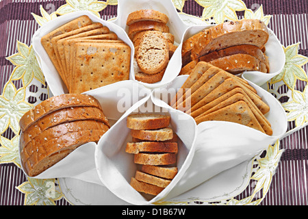 Bakery set. Cereal bread, dry biscuits and crackers in textile serving basket Stock Photo