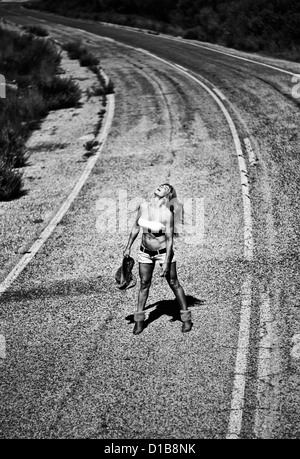 Woman alone on road. Stock Photo