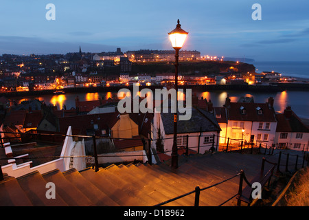 View of the coastal town of Whitby at dusk, looking north across the river Esk from the 199 steps. Stock Photo