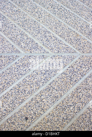 Close up paver walkway pattern intersection with a couple of leaves on ...